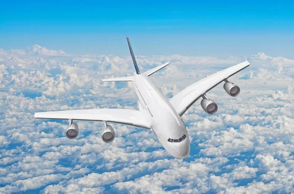 Passenger huge liner airplane fly above clouds and blue sky. — Stock Photo, Image