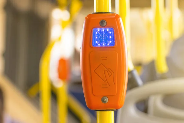 Modern prepaid public transport ticketing system, payment by bank cards, with validation machine at entrance of bus and other public transport in the city.