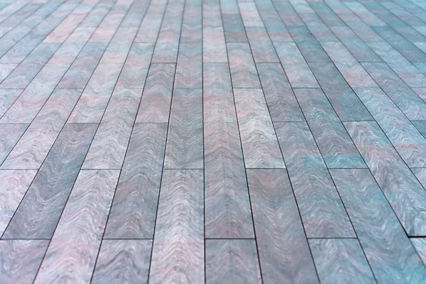 The surface with elongated rectangular stone tiles goes into perspective. — Stock Photo, Image
