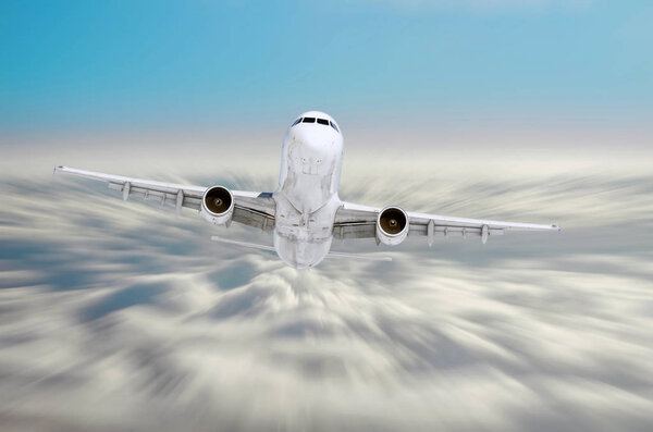 Passenger airplane is climbing high flight level in the sky above the clouds, motion speed blur.