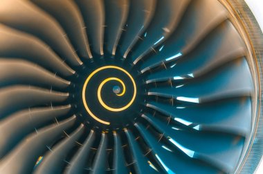 Background turbine blades rotate jet engine aircraft close up. clipart