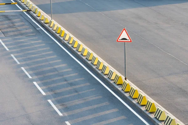 Sign speed bump at the exit to the highway.