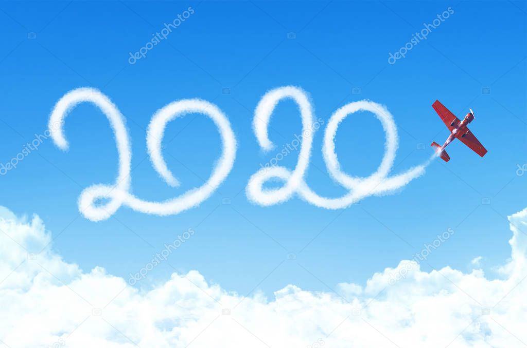 Happy New year 2020 concept on the background below cloudscape. Drawing by passenger airplane white vapor contrail in sky.