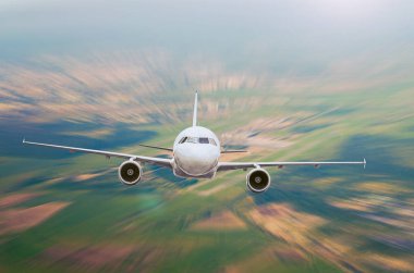 Airplane is gaining height against the background of a remote airport.