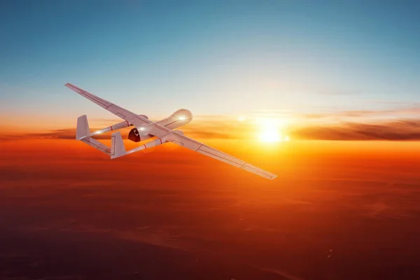 unmanned military aircraft in the evening sky flies to the horizon