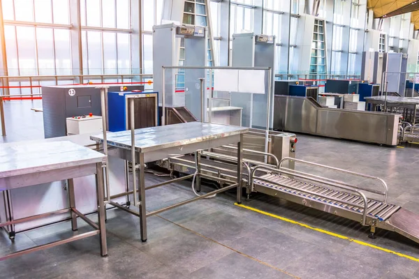 X-ray machine for screening passenger luggage with frame metal detector tables for inspection of things at the airport check-in counter