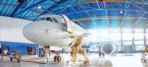 Panoramic view of aerospace hangar, civil aviation aircraft, repair and maintenance of mechanical parts in an industrial workshop