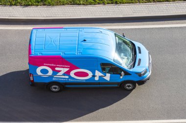 Mini van truck for delivery to points of delivery of the online store Ozon.ru rushing rides highway city road. Russia, Saint-Petersburg. 14 april 2020 clipart