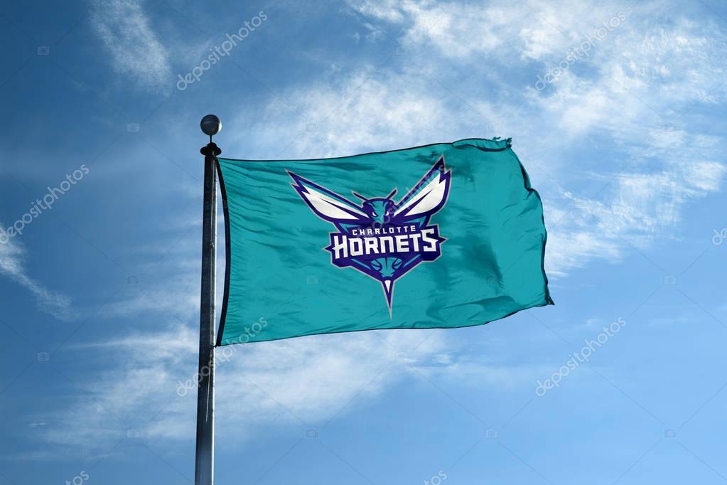 CHARLOTTE - October 24, 2017 - Waving flag on the mast with Charlotte Hornets NBA basketball team logo, United States.