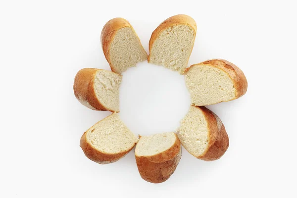 Round bread sliced on a white background. Isolated — Stock Photo, Image