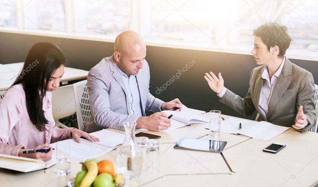 Business meeting between three professional partners early in the morning