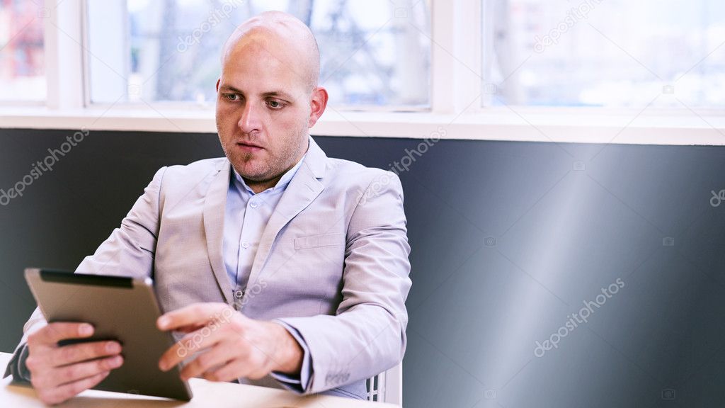 Business man holding and using a high tech tablet