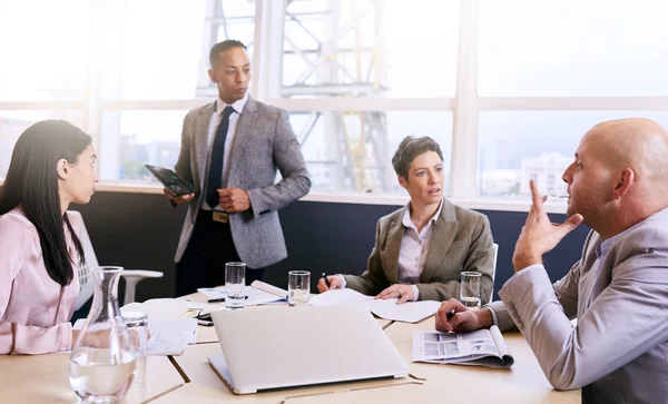 Businessman giving a presentation with electronic tablet in his hands — Stock Photo, Image