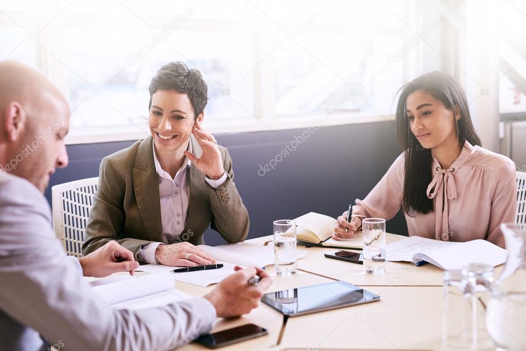 Business meeting between three professional partners early in the morning