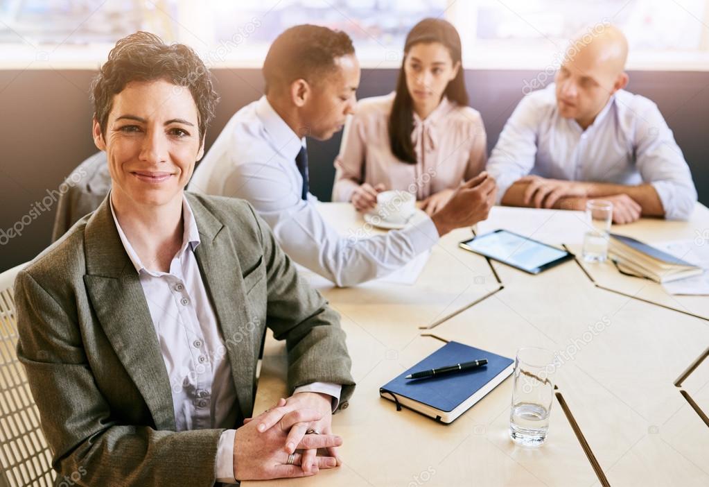 Mature businesswoman looking at the camera during business meeting