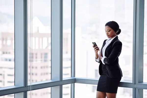 Reife schwarze Geschäftsfrau SMS schreiben, während stehend — Stockfoto