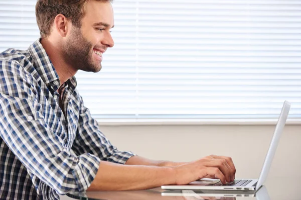 Profile image of handsome groomed man typing on laptop computer — Stock Photo, Image