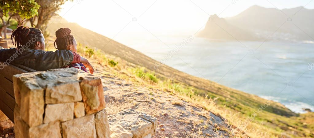 view of the ocean and mountains being admired by couple