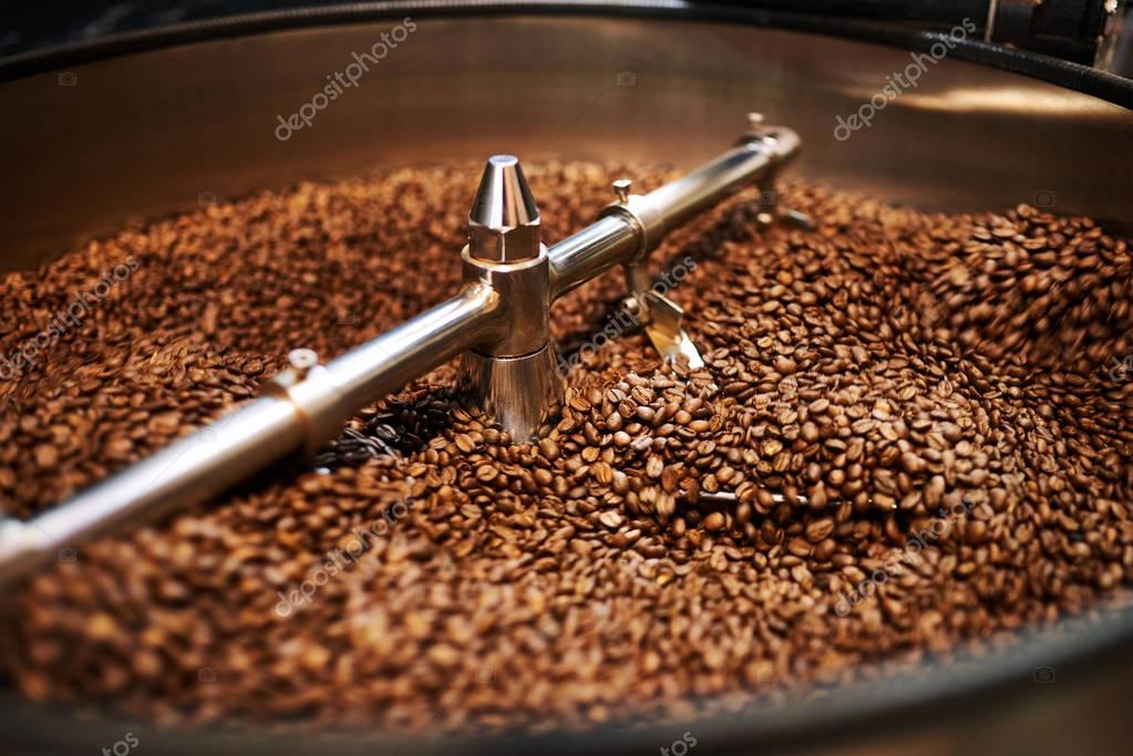 Coffee beans mixing in cooling drum after being freshly roasted — Stock
