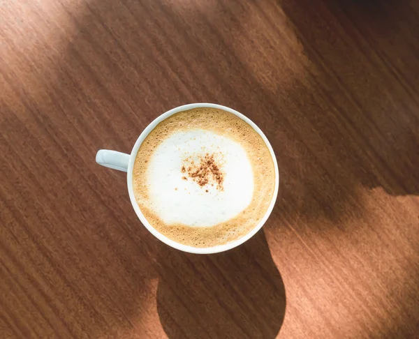 Cappuccino cup on wood table — Stock Photo, Image