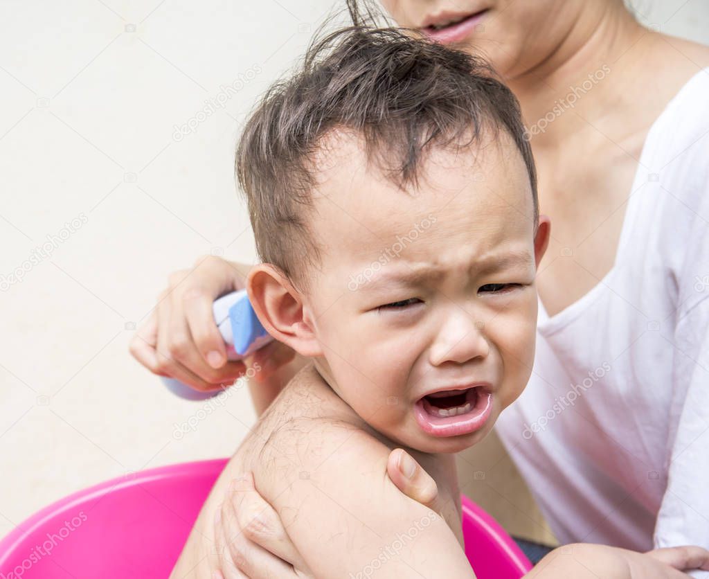 crying Thai baby feel scare of hair clipper 