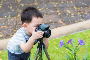 Yakışıklı Asyalı çocuk tarafından dijital SLR bir fotoğraf almak 