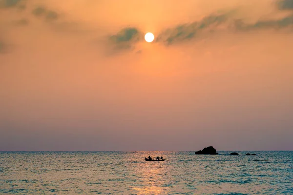 the silhouette photography of Thailand sea , a fishing boat agai