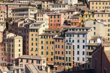 Group of palaces facades of Camogli, painted with famous pastel colors. Camogli is a small fisherman village on the shores of the Ligurian Sea. (Northern Italy); during summertime became full of tourists, coming from all Italy and abroad.