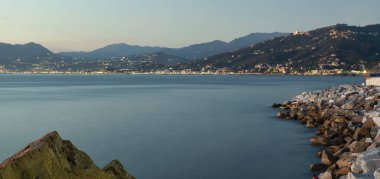 Panoramic view of the seashores of Sestri Levante, Ligurian Sea, Northern Italy); in the background, the lights of Chiavari and Lavagna (both Genoa Province, Liguria). clipart