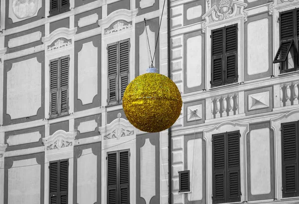 Characteristic facade of an ancient house of Camogli, with a big brilliant ball, hanged as Christmas decoration. Camogli is a small fisherman village on the shores of the Ligurian Sea. (Northern Italy); during summertime became full of tourists.