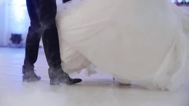 Man legs making clumsy movements trying to dance with woman in huge gown skirt close up POV slow motion. Funny mistakes while partners dancing at ballroom competition. Feet dance in dry ice and neon — Stock Video