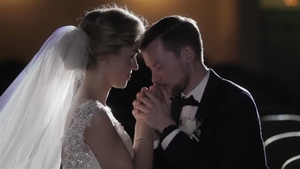 Man kiss hand of woman close up studio light. Groom kind taking care of bride kiss forehead romantic tenderness affection love marriage wedding vows concept. Couple in love fond of as two young doves — Stock Video