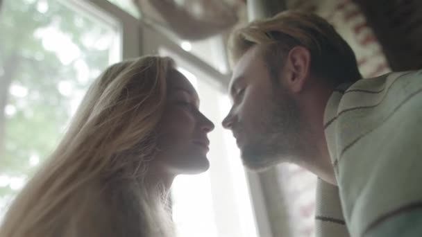 Couple in love have sweet moment together kissing and touching noses close up slow motion. Man and woman enjoy each other gently embracing at home. Harmony and romantic relationship — Stock Video © Couple in love have sweet moment together kissing and touching noses close up slow motion. Man and woman enjoy each other gently embracing at home. Harmony and romantic relationship — Stock Video ©