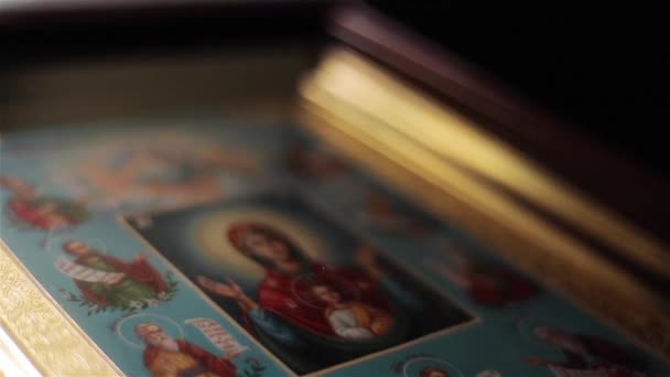 Icon image of Virgin Mary in St Nicholas Orthodox Cathedral in Nice France macro close up light moving. Framed painting of Mother of God in Orans position with Child Jesus attended by Saints — Stock Video