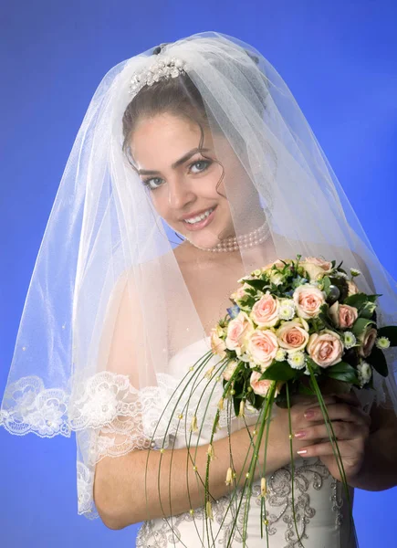 Beautiful young bride in veil and dress on Blue background. Bare — Stock Photo, Image