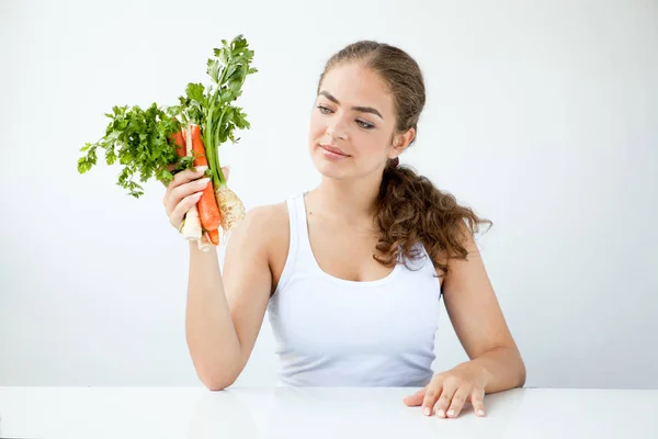 Beautiful young woman holding healthy food in hands on the light — Stock Photo, Image