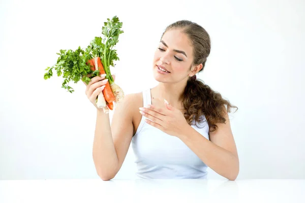 Beautiful young woman holding healthy food in hands on the light — Stock Photo, Image