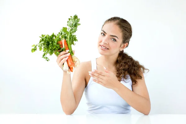 Beautiful young woman holding healthy food in hands on the light — Stock Photo, Image