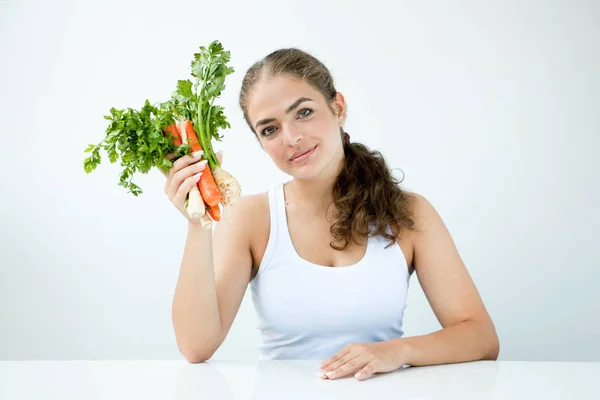 Beautiful young woman holding healthy food in hands on the light — Stock Photo, Image