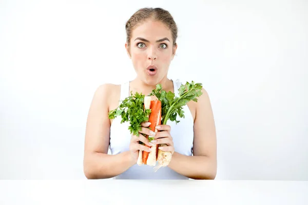 Beautiful young woman holding healthy food in hands on the light — Stock Photo, Image