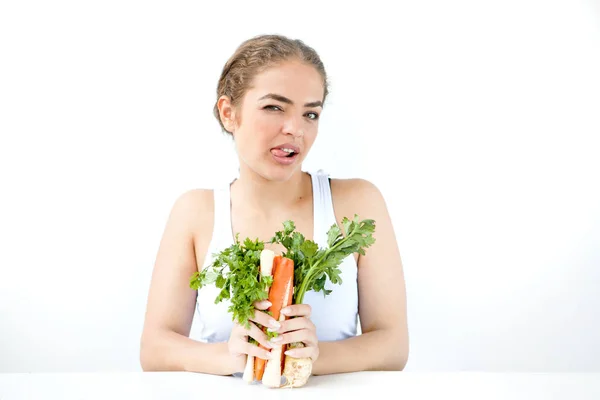 Beautiful young woman holding healthy food in hands on the light — Stock Photo, Image