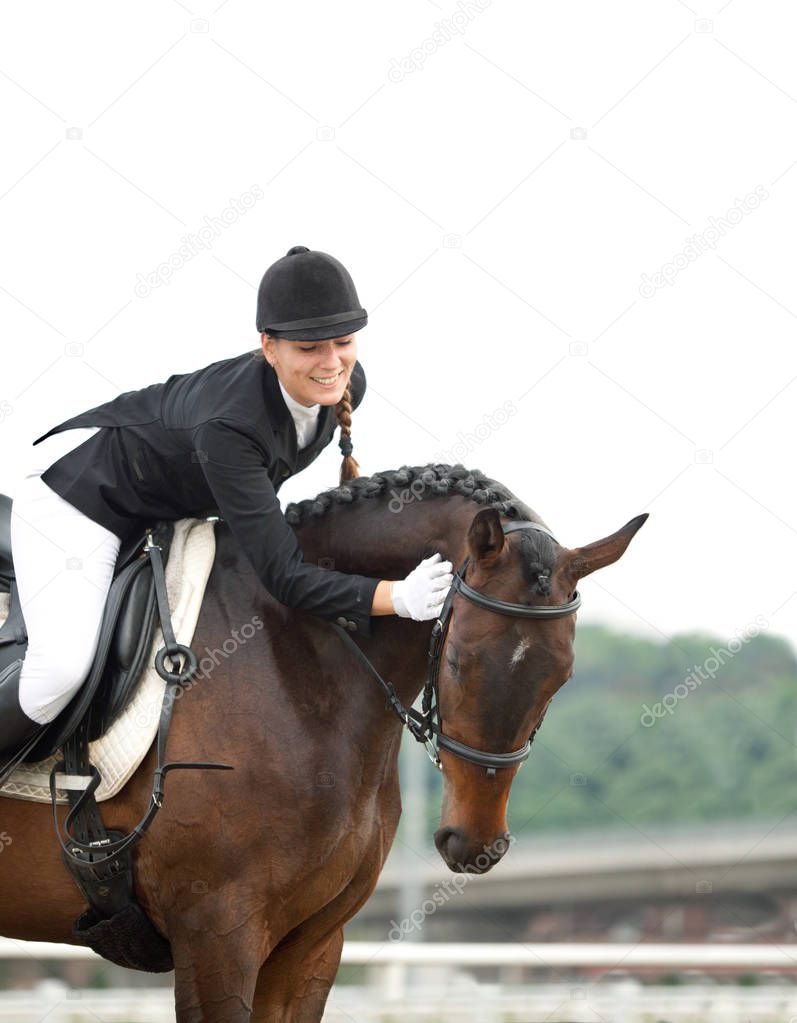 Attractive Young Woman in Jockey suit Riding, Stroking her Horse