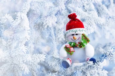 Christmas Snowman Hanging on a Snow Tree Branch clipart