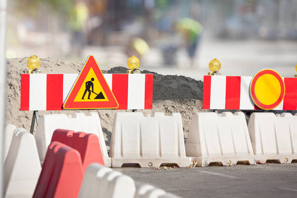 Road Repair Sign in the City Street 