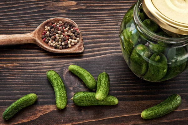 Green Cucumbers, Back and Red Pepper on the Wooden Table