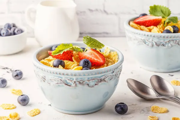 Healthy breakfast - corn flakes with fruits and berries.