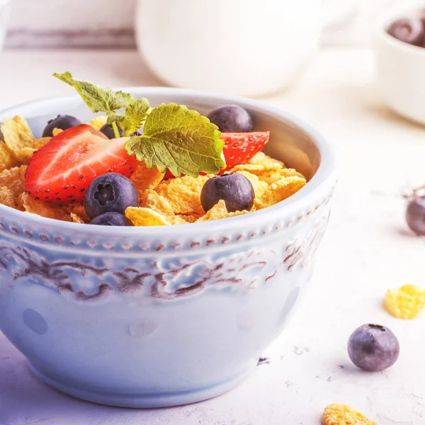 Healthy breakfast - corn flakes with fruits and berries.