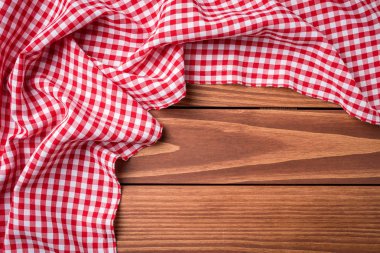 Ahşap masa üzerinde kırmızı katlanmış masa örtüsü