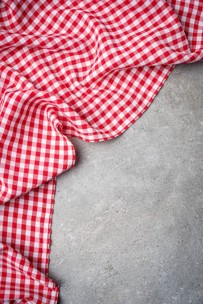 灰色の石のテーブルに赤い折り畳まれたテーブルのクロス トップ ビュー — ストック写真