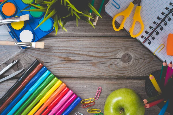 School supplies on wooden table with empty notebook. — Stock Photo, Image